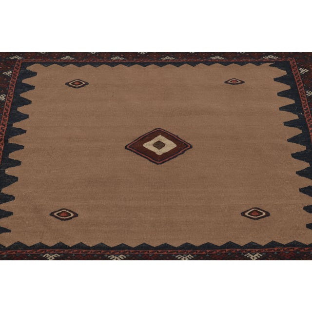 Made with handwoven wool circa 1950-1960, this 4x4 vintage square flat-weave Sofreh Kilim is a particularly meditative and...