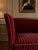 A beautiful Danish loveseat in the Henningsen style, Denmark, circa 1960s. Upholstered in rich deep burgundy mohair with...