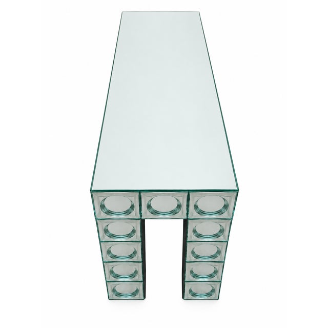 Modern console table with a silvered glass top, contemporary style. Glass and wood frame. Curved, reflective mirrored...