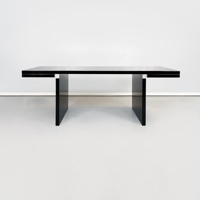 Dining table model Orseolo with rectangular top in black lacquered wood, like the entire structure. The structure is made...