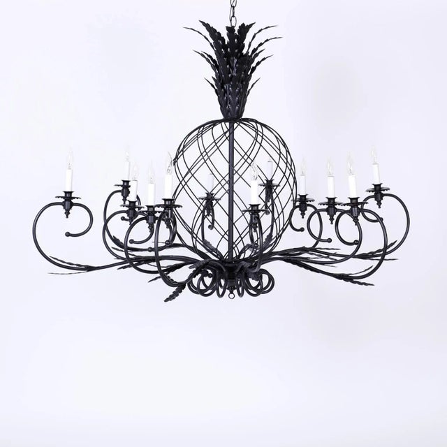 Impressive large-scale pair of twelve-light black metal chandeliers in the form of stylized pineapples. Perfectly...
