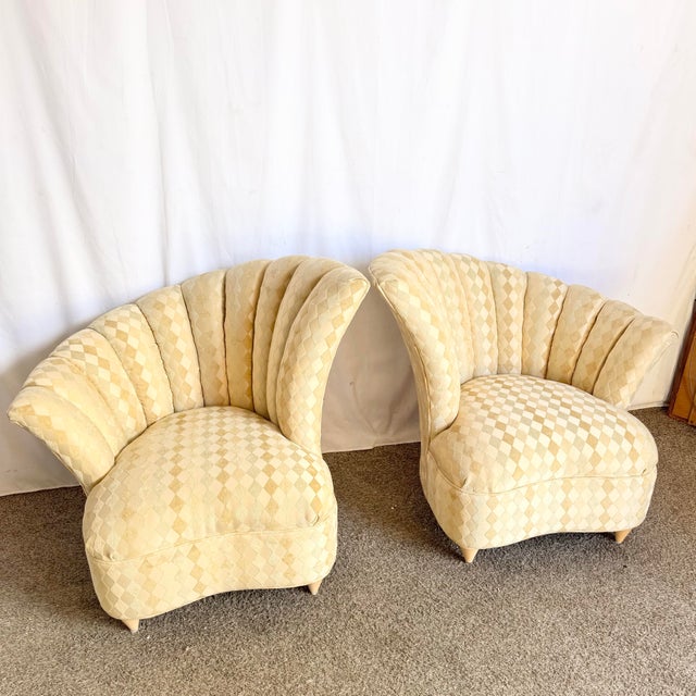A striking pair of postmodern lounge chairs defined by dramatic, ascending clam shell silhouettes. Upholstered in a soft,...