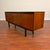 Vintage mid-century teak sideboard by White & Newton, made in the U.K. circa 1960's. This piece features beautifully book-...