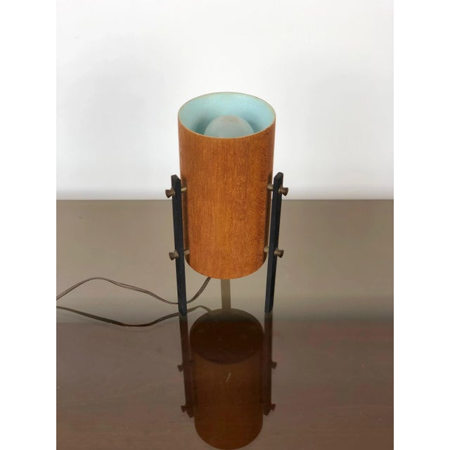 Tripod table lamp in teak and metal, 1960s, Scandinavian. Up to 250V (Europe/UK Standard).The wiring of this item may be...