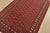 A tribal Bokhara rug hand-knotted with fine wool on a cotton foundation. This rug features rows of repeating medallions...