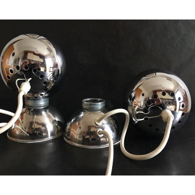This pair of vintage table lamps in chromed steel was manufactured in Italy in the 1970s. This piece has an attribution...