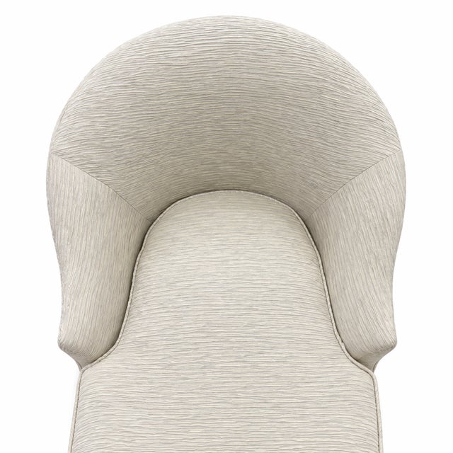 A more contemporary interpretation of the classic chaise. This piece is defined by its smooth, sculpted lines and...