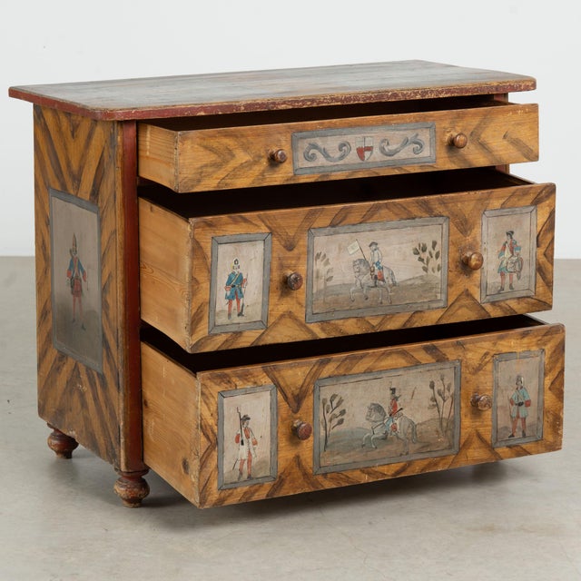 19th century chest of three drawers, crafted in pine with a remarkable original hand-painted folk art finish. Detailed...