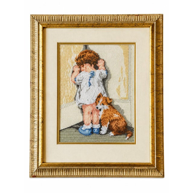 Charming set of two framed needlework pictures featuring a young child and a dog in sweet, nostalgic scenes. Beautifully...