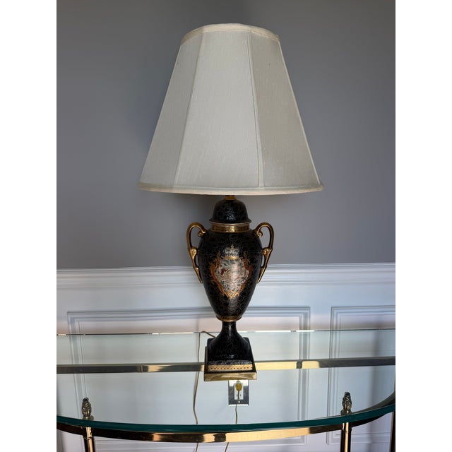 A striking vintage Remington table lamp featuring a classic urn-form silhouette with richly detailed black crackle glaze...