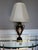 A striking vintage Remington table lamp featuring a classic urn-form silhouette with richly detailed black crackle glaze...