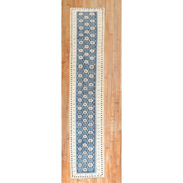 A mid-20th century geometric skinny Turkish runner in blue and white Measures: 1'8'' x 8'1''.