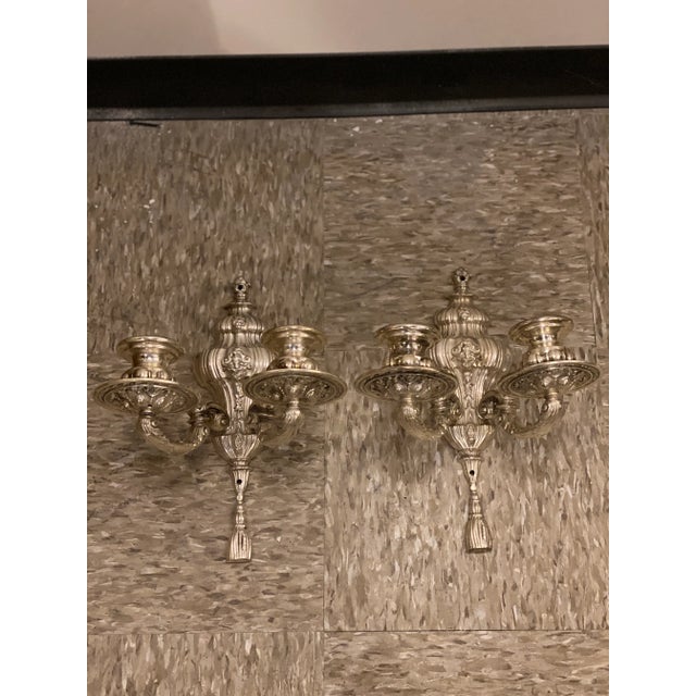 A pair of circa 1920’s Caldwell silver plated engraved sconces with 2 lights