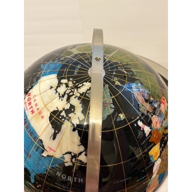 Semi-precious stones featuring black onyx as the ocean, and over 25-30 other gemstones and shells to create this globe...