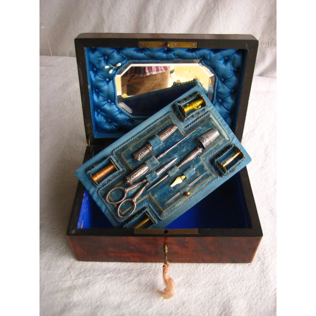 Splendid sewing box in a luxury inlay box that plays very elegantly with the different colors of wood to create stunning...