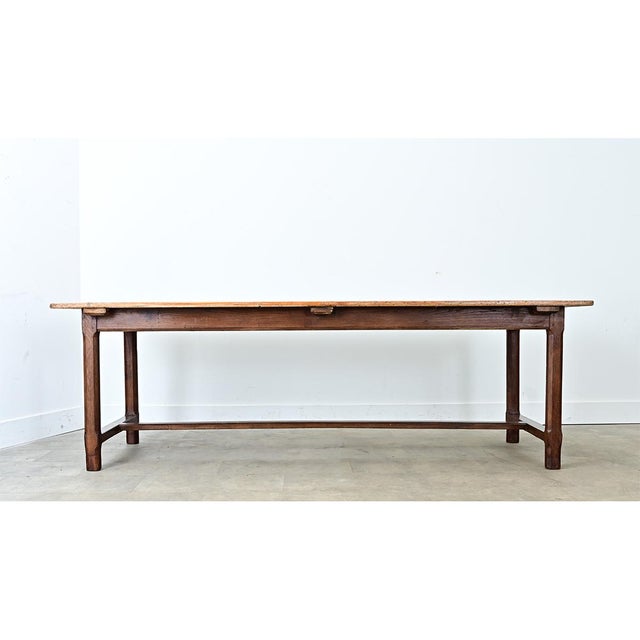 A 19th-century French farm table made from pine and oak. The top consists of 6 long tongue and groove pine planks, whose...