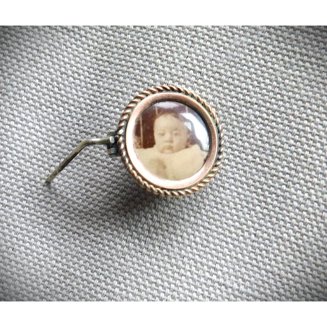 Antique 10K Petite Baby Sepia Colored Portrait Brooch Pin with a diagonally ribbed frame and adorable picture of a young...