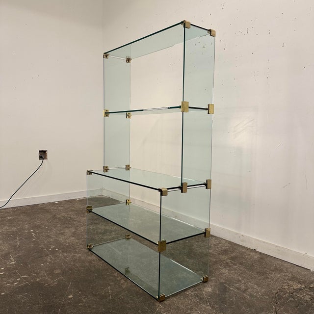 This is a beautiful Pace Collection glass and brass etagere or bookcase. It features a two-tiered body made of 3/8” thick...