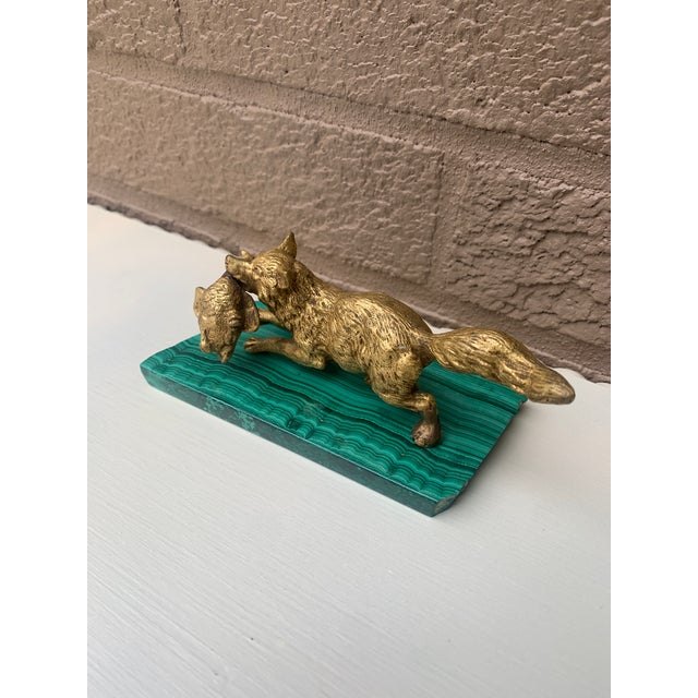 A beautiful antique gilt bronze sculpture of a hunting fox with a duck in its mouth, mounted on a polished malachite slab...