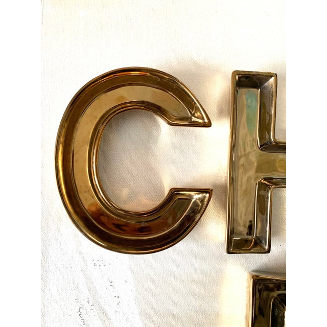 What a fun set of letter shaped gilt ceramic dishes! Each measuring 4.5x6x1”h , spelling out the word “Cheers”, fill them...