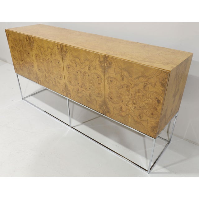 Elevate your interior with this dramatic and beautifully book matched burled olivewood sideboard Attributed to Milo...