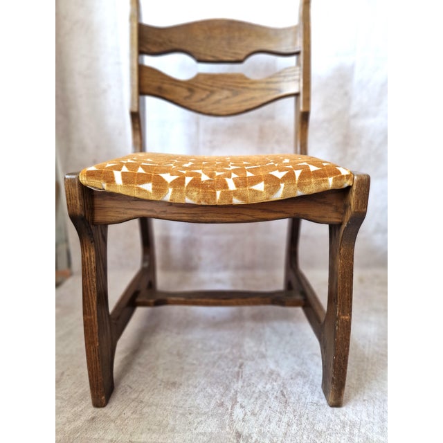 Set of six oak chairs in the style of Guillerme and Chambron. They have been completely reupholstered in an ochre linen...