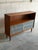 Beautiful vintage Danish modern teak cabinet featuring sleek tambour sliding doors, open shelving, and elegant tapered...