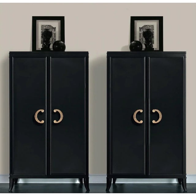 The closet features two doors enriched with hand-applied gold leaf handles which add a glamorous allure to the piece....
