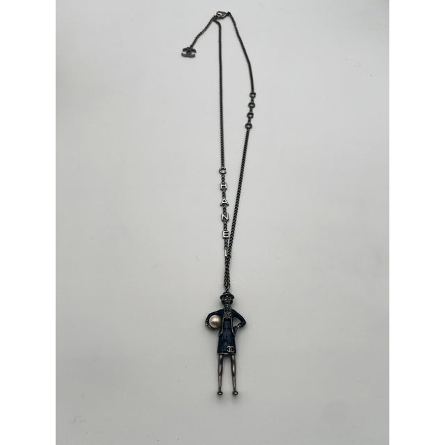 Chanel fall 2012 long necklace COCO on one side CHANEL on the other side, Gabriel Chanel wearing a Chanel suit and iconic...