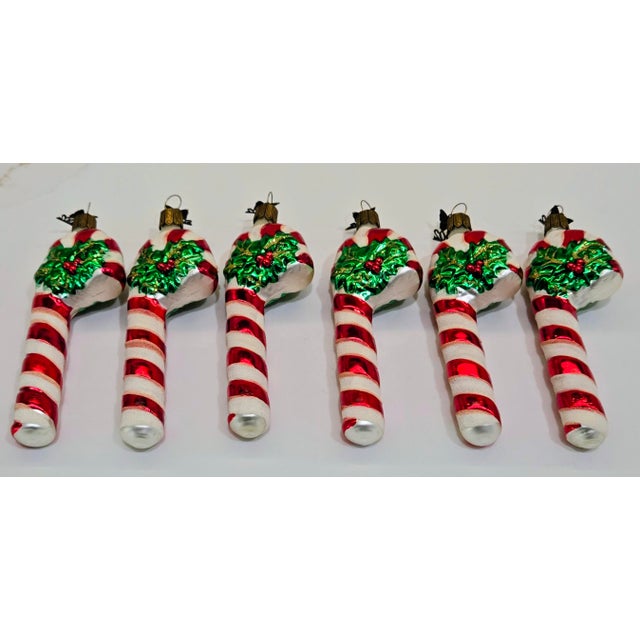 A festive and increasingly collectible set of six Neiman Marcus Christmas ornaments from the 2002 holiday collection, made...