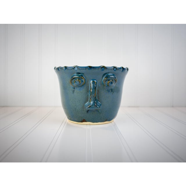 Charming handmade studio pottery sculpted face planter with a pinched, ruffled rim. This piece was acquired from a notable...