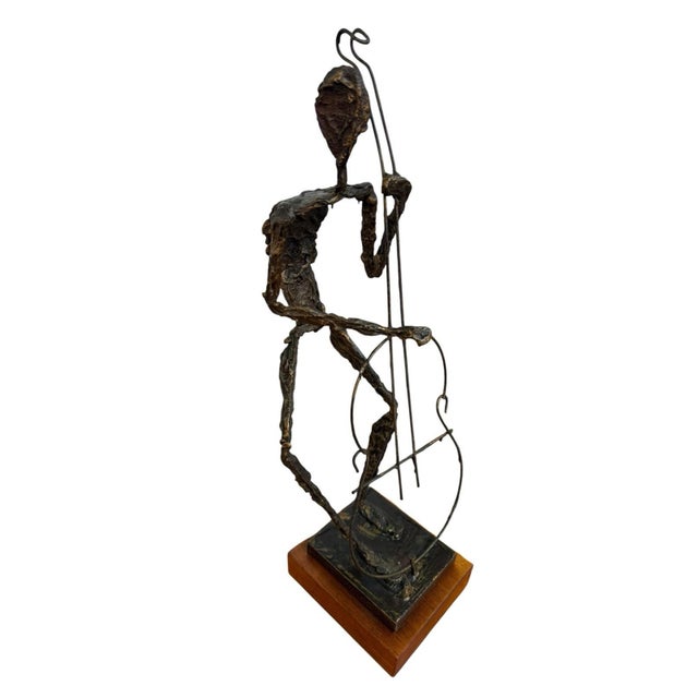 This Mid-Century Brutalist Musician Figurine Sculpture features a drummer drummer on a wooden pedestal, embodying the...