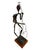 This Mid-Century Brutalist Musician Figurine Sculpture features a drummer drummer on a wooden pedestal, embodying the...