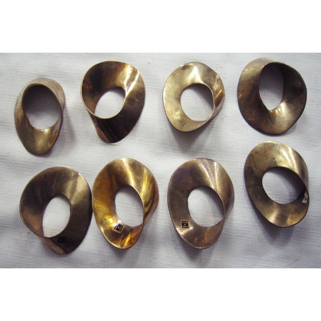 60's era Brass Napkin Rings from India. Interesting shape. In original, unpolished patina, each measures 3"H x 2"W x .5"D....