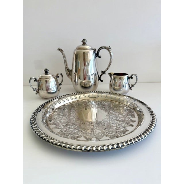 This elegant vintage silverplate tea/coffee service features 1 tea/coffee pot by Wm. Rogers & Son, paired with a...