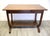 Early 20th-century Arts & Crafts oak library table featuring distinctive lyre-form side supports, a single drawer with...