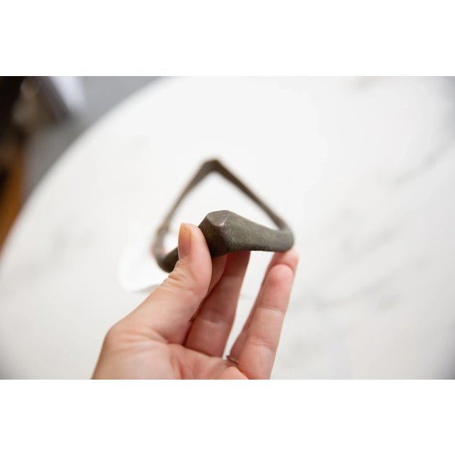 :: Vintage handmade African bronze curved artifact. Circa early 20th century and possibly older, this unique piece has...