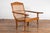 An antique Dutch Colonial Indonesian cane and wood plantation chair from the 20th century with extending arms and turned...