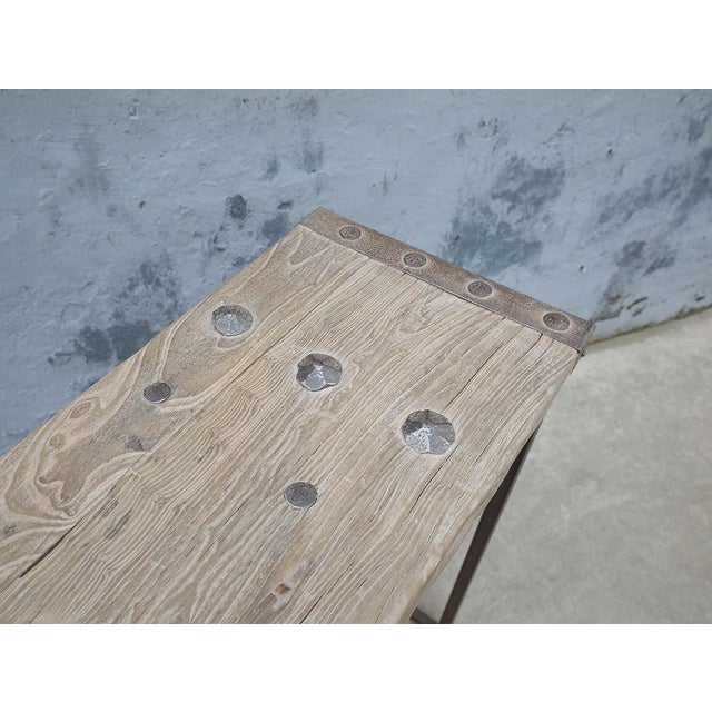 A distinctive console table made from an element of a Chinese compound gate, paired with a clean, minimalist iron base....