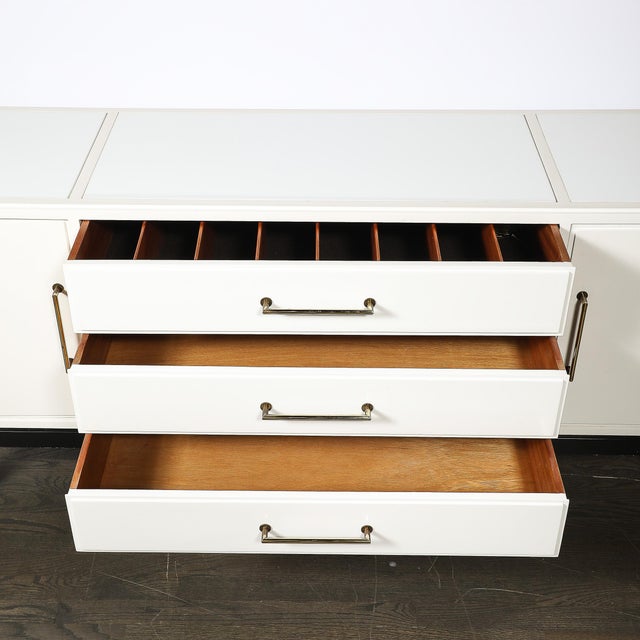 This mid-century modernist sideboard, designed by Tommi Parzinger and crafted in the United States, circa 1950, is a...