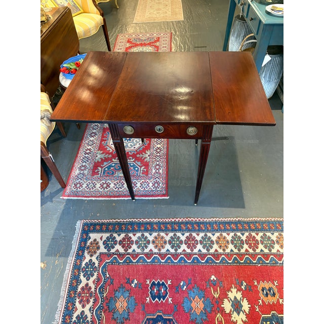 This is an antique mahogany drop leaf table.. It is in the Federal style. It is 40" wide when the leaves are completely...