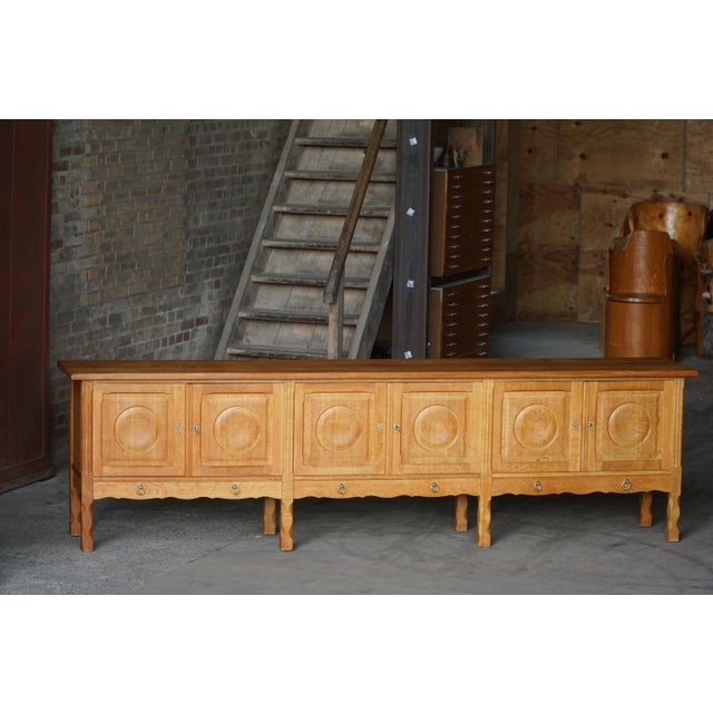 A rare & long beautiful low sideboard crafted in solid oak, made in the 1960s by Henning Kjærnulf. The piece combines...