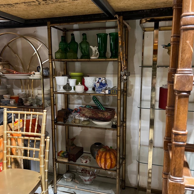 Up for consideration is a beautiful vintage brass bamboo style bookcase with glass shelves. This would look lovely in your...