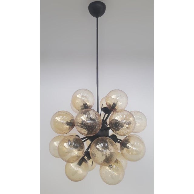 Italian sputnik chandelier with 24 amber Murano glass globes carefully hand blown with bubbles inside the glass using...