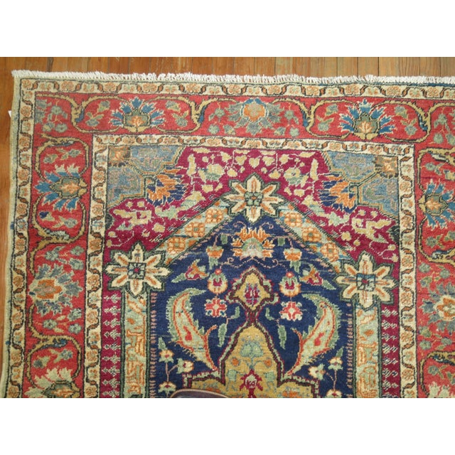 A vintage Turkish Kula Carpet. Predominant accents in blue, red, purple and green.