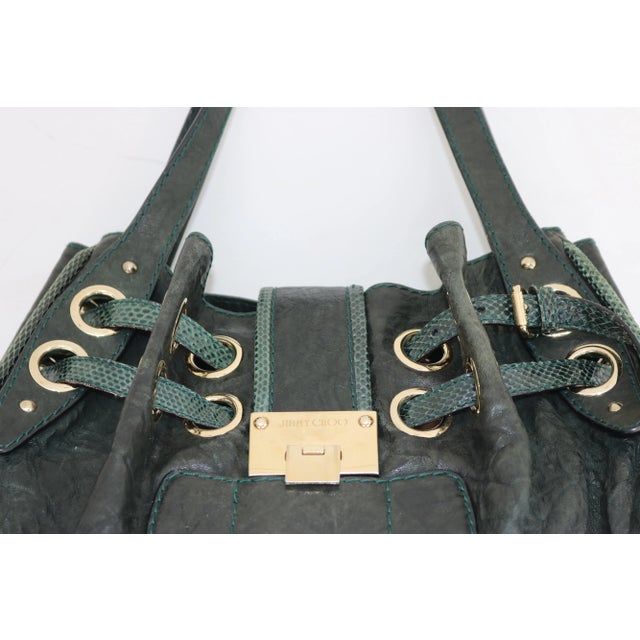 Own this gorgeous Jimmy Choo Riki tote today and light up your life! Beautifully Crafted from dark green crinkled leather...