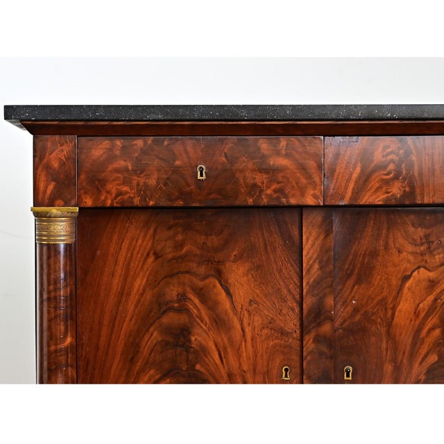 A stunning 19th-century French enfilade, made in the Empire style with finely crafted mahogany and gilt bronze accents....