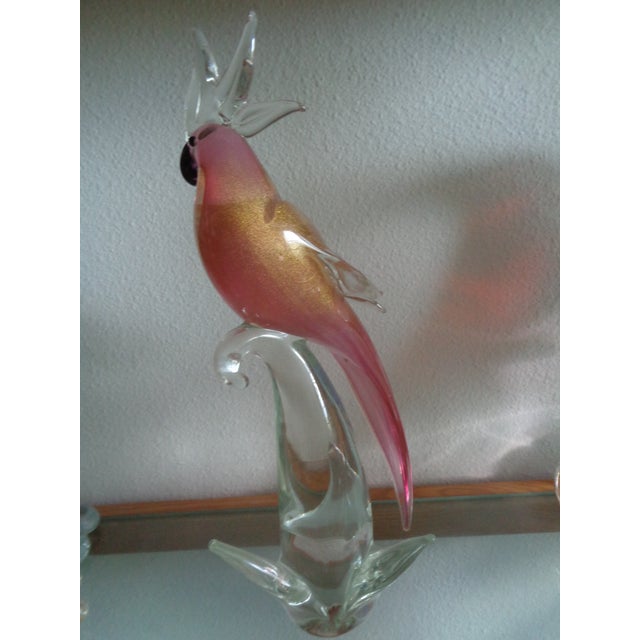 This is probably a Murano art glass cockatoo sculpture featuring a pink and gold aventurine sommerso body perched on a...