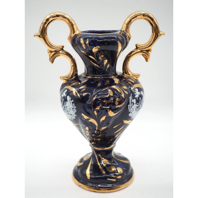 Elegant italian decorative vase in dark blue glossy glaze with rich hand-painted gold detailing and a classic white cameo...