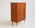 Teak chest of drawers with six front drawers, integrated carved handles, and tapered solid wood legs. Scandinavian...